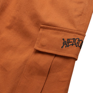 Up close view of cargo pocket and embroidered logo. Two hidden snap closure buttons  under flap.