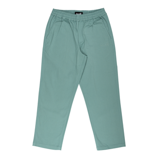 Front view of (dusty teal) "Petrol" principal elastic waist twill pants. Tonal scrawl logo embroidered on left thigh. Two pockets on each side.
